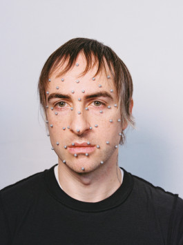 Artist portrait of Valentin Gillet, face with grey motion capture dots on a plain grey background. Valentin-Gillet